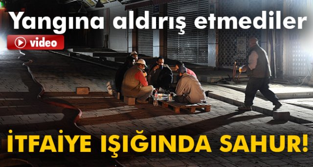 Yangına aldırmayan işçiler itfaiye ışığında sahur yaptı